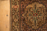 Stepped corner spandrel and intricate floral border on a vintage Persian Sarouk mat.