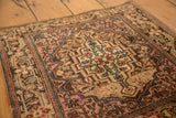 Corner detail of a vintage Sarouk rug showing its stepped spandrel and time-softened hues.
