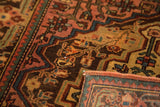 Vintage Josan Sarouk rug with corner folded to show the back weave and short pile texture.
