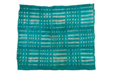 Hand woven vibrant green African mudcloth throw with white dot and dash patterns.