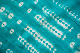 Unusual green indigo mudcloth with white geometric patterns and stitched texture.