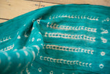 Unusual green and white African mudcloth with abstract patterns and woven texture.
