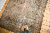 Antique Malayer rug with open holes, worn pile, and faded central medallion.