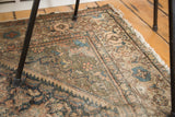 Distressed antique Mission Malayer rug section, with softened green, blue, and terracotta floral patterns.