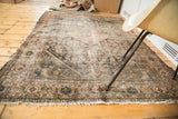 Distressed antique Mission Malayer rug showing frayed fringe and geometric patterns.