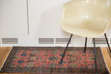 Vintage Lilihan Sarouk rug with cranberry red field, soft cobalt blue flowers, and dark blue border.