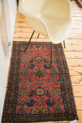 Traditional Lilihan Sarouk rug: cranberry red field, cobalt blue floral motifs, detailed border.