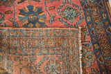 Lilihan Sarouk's folded corner, hand-knotted pile, cranberry field, cobalt blue motifs, and fringe.