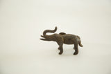 Vintage African iron elephant casting, side view with textured dark finish.