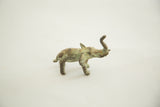 Vintage African bronze elephant casting with raised trunk, mottled green patina.
