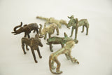 Vintage African bronze crocodile casting among animal sculptures, with prominent green patina.