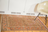 Peachy pink and camel brown tones on the uni-directional pattern of a vintage Indo Caucasian rug.