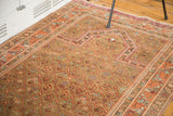 Vintage Indo Caucasian rug featuring a stepped geometric design in camel and peachy tones.