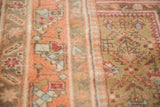 Soft hand-knotted pile of the Vintage Indo Caucasian rug in peachy pink and camel tones.