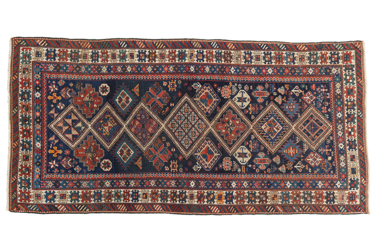 Hand-knotted antique Fine Caucasian rug with geometric medallions on dark indigo. 3'4" x 6'6".
