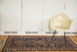 Antique Fine Caucasian rug; repeating geometric medallions, tangerine, brick red, and indigo.
