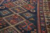 Intricate diamond motifs in mallard green, tangerine, and brick red with complex geometric borders on this antique Caucasian rug.