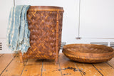 Round, hand-woven vintage rattan basket lid in natural brown tones.