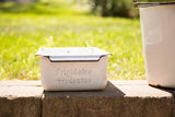 Vintage Frigidaire Hydrator tray in white enamel with embossed lettering and a black rim.