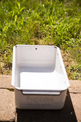 Angled perspective inside the white enamel vintage tray.