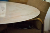 Vintage marble tulip table with a smooth, light cream top and soft veining.