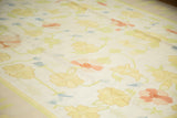 Vintage Dhurrie with yellow, blush, and light blue scrolling florals.