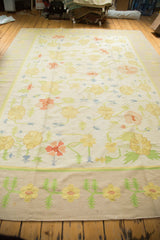 Detail of vintage Dhurrie rug's lower border and field with yellow, blush, blue florals.