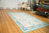 Expressive honeydew green, rose, and sky blue florals on an eggshell vintage Dhurrie field.