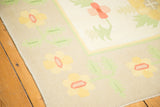 Vintage Dhurrie rug border, beige ground with yellow, soft blush, and green motifs.