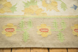 Vintage Dhurrie carpet detail: 1980s flatweave, yellow and blush floral motifs with green leaves.