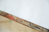 Patina and texture detail on the aged edge of the antique landscape painting.