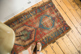 Distressed antique Bakshaish geometric pattern in red, mint green, and ocean blue.