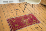 Gold ribboned border with stylized motifs on distressed cinnabar antique Oushak rug.