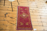 Distressed cinnabar red Turkish Oushak rug with gold ribboned border and cloudband motifs.