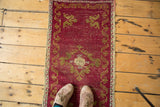 Distressed cinnabar red Turkish Oushak rug mat with floating gold ribboned border.