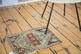 Distressed geometric pattern featuring brick red blossoming flower designs on an antique Oushak rug.