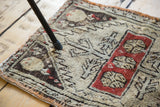 Distressed hand-knotted pile with geometric serrated tree and blossoming flower motifs in brick red and ivory.