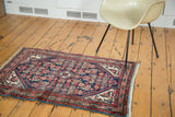 Vintage Tajabad rug with diamond medallion, herati motif, indigo blue, rust red, and ivory.