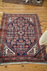 Intricate herati motif on indigo blue field with rust red and ivory border.