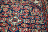 Vintage Tajabad rug's intricate Herati motif, diamond medallion, with indigo, rust, gold, and ivory.