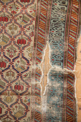 Heavy tatter and a large split revealing the foundation of a finely woven antique Caucasian rug.