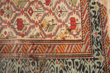 Corner detail of an antique Marsali rug showing its rare light blue and charcoal geometric border.