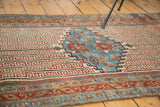 Antique Malayer rug detail, featuring aqua blue shadow design and ruby red Greek key patterns.