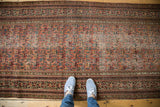 Distressed vintage Persian runner displaying Guli Hannai field pattern and ornate Serbend borders.