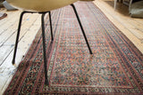 Distressed Mir Serbend runner close-up, featuring worn Guli Hannai pattern in muted terracotta, blue, and ivory.