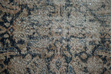 Heavy distress and faded dark teal herati pattern texture on this antique Hamadan rug.