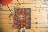 Antique Malayer rug corner with faded blush red, indigo blue, ivory pictorial motifs.