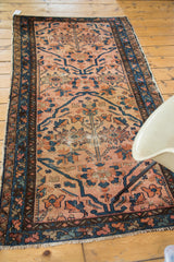 Antique Persian Lilihan rug, blush and gold field, indigo splayed floral patterns.