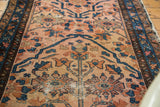 Antique Lilihan rug's blush rose field with indigo outlines and curvilinear floral patterns.