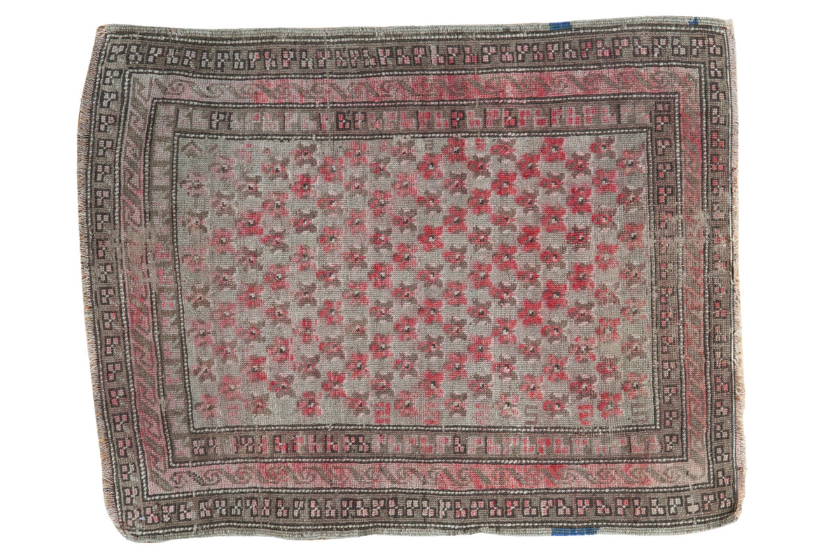 Circa 1910s antique Caucasian mat with hot pink star motif and distressed beige field.